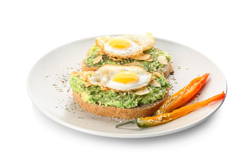 Delicious toasts with avocado and eggs on plate, isolated on white
