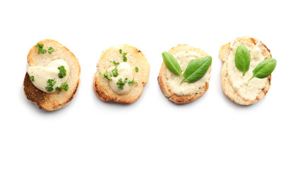 Toasted bread with cream cheese and herbs on white background