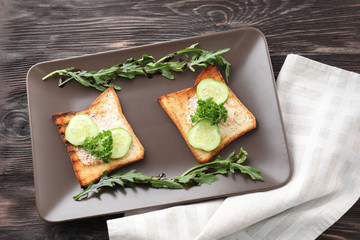 Toasted bread with cucumber on plate