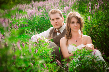 bride and groom portrait on the background of a mountain and grass
