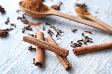 Aromatic cinnamon sticks on wooden background, closeup