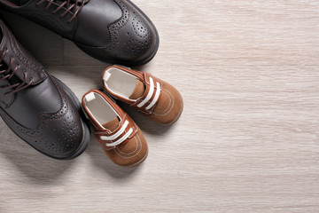 Big and small shoes on light background. Father's day