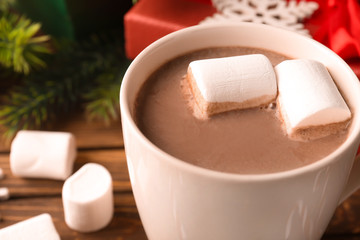Cup of hot cocoa with marshmallows on table, closeup