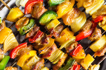 close up shut of a meat en brochette on the grill