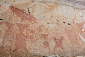Rock art includes both humanoid and animal figures on cliffs above the Mekong estimated to be 3,000 years old at Pha Taem National Park in Ubon Ratchathani, Thailand