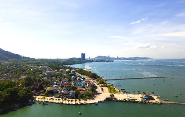 Aerial view of sea beach with city and island background