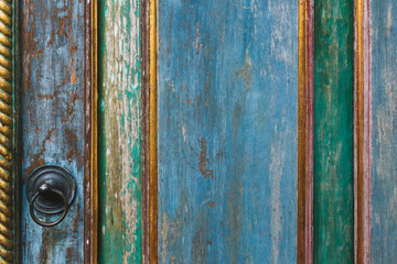 Wooden painted shabby texture of door with metal knob