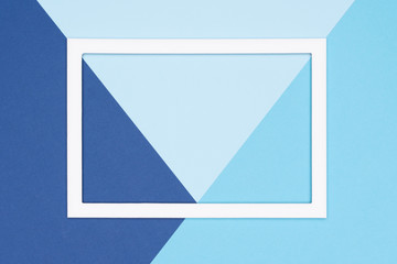 Abstract geometrical flat lay pastel blue colored paper background. Minimalism, geometry and symmetry template with empty picture frame mock up.