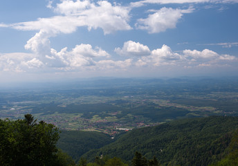 View from Medvednica, Sljeme mountain in Zagreb, Croatia. Landscape photo with blue sky, white clouds and green trees