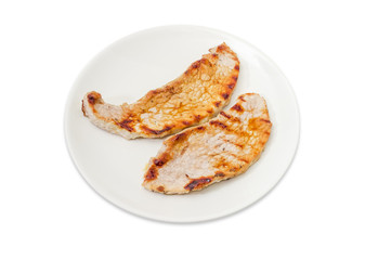 Grilled sappy pork steaks on the white dish