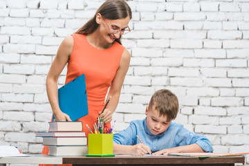 Teacher woman helping student with difficult task in school 