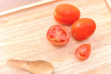 Sliced and Whole Red Tomatoes Isolated on Wooden Board