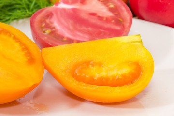 Pieces of yellow and red tomatoes at selective focus