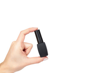 Black nail polish bottle with hand isolated on white background, copy space template