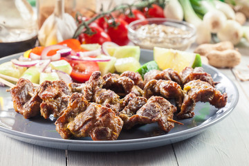 Traditional pork satay with peanut sauce and vegetables