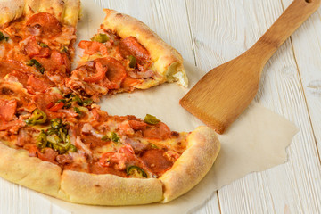 Pizza on a white woodwn table