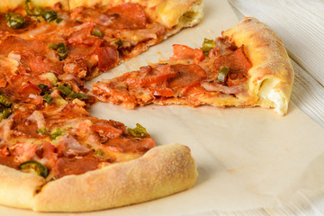 Pizza on a white woodwn table