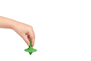 Green toy giroscope with kid hand, isolated on white background. copy space template