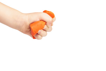 Orange plasticine bar with kid hand, isolated on white background. copy space template