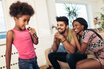Black family enjoy singing karaoke