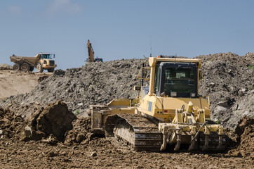 CONSTRUCTION MACHINERY - Dump truck and bulldozer on construction side