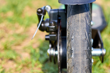 Black folding kick scooter, close up parts, disk brakes