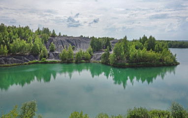 Abandoned sand quarry to the blue lake. Konduki, Tula region, Russia. 