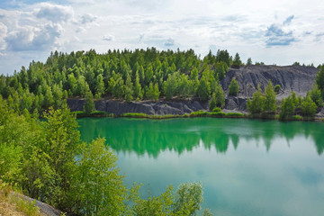 Abandoned sand quarry to the blue lake. Konduki, Tula region, Russia. 