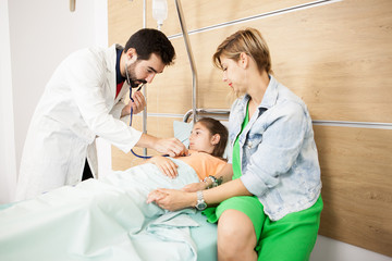 Fototapeta premium Doctor checking her patient heart in hospital 
