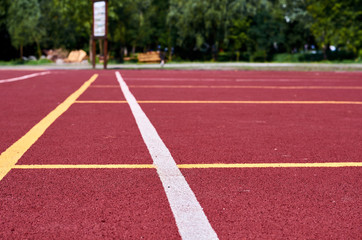 Decorative rubberized Jogging coating at the street stadium in outdoor with white line. Sport...