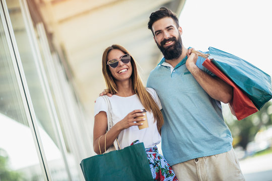 Beautiful Couple Enjoy Shopping Together, Young Couple Holding Shopping Bags