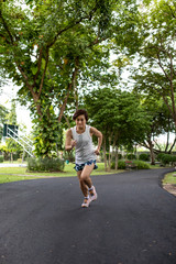 Asian woman running in the park with high intention feeling