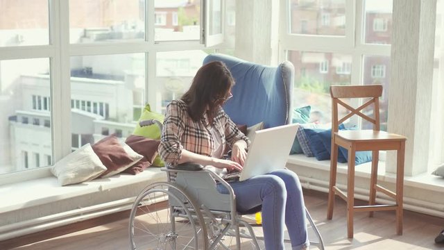 Young woman disabled by a business employee in a wheelchair.