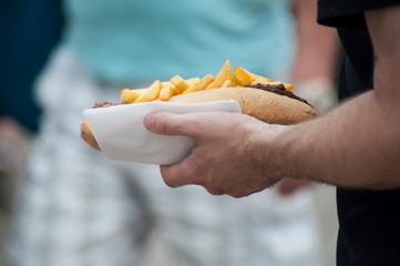 closeup of american sandwich in hand in outdoor
