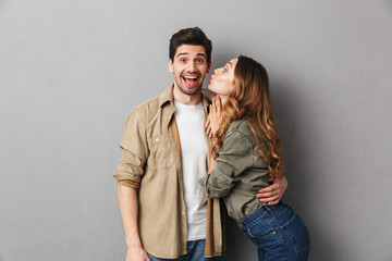 Excited young couple hugging and kissing