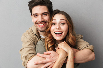 Excited young couple hugging