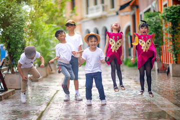 kids children joyfully playing around together in group