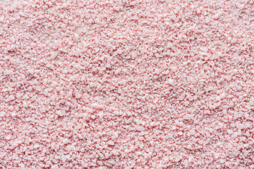 top view of pink sea salt background, spa treatment concept