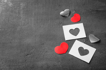 Composition with paper hearts on grey background
