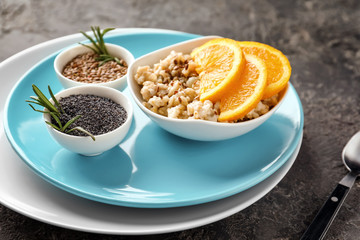 Composition with tasty oatmeal on dark textured background