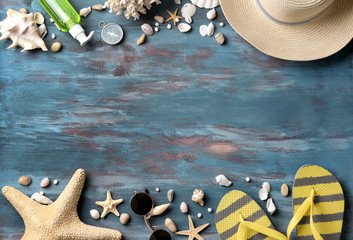 Beach accessories on color wooden background