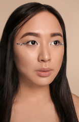 Fototapeta premium Portrait of beautiful Asian woman on light background