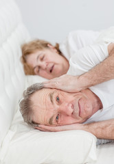 senior man who can not sleep because his wife snores