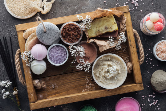 top view of spa and bath accessories in wooden box on grey