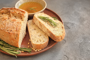 Plate with fresh tasty bread and oil on table