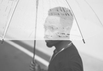 Fototapeta na wymiar African man using an umbrella