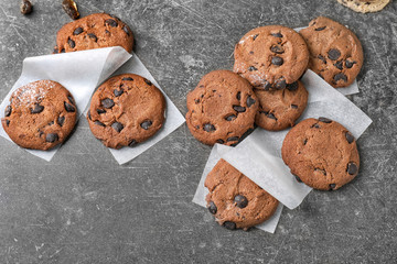 Delicious cookies with chocolate chips on dark background