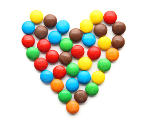 Heart made of colorful candies on white background