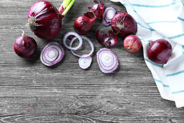 Red onions on wooden background