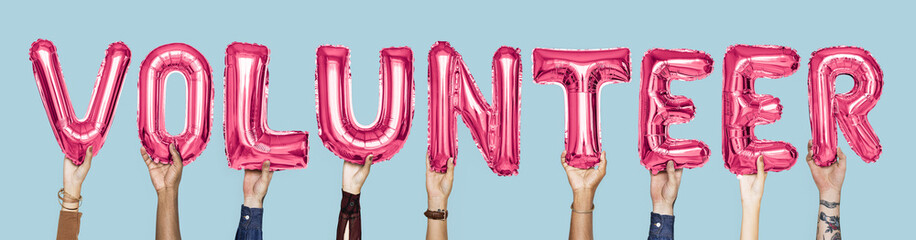 Pink alphabet balloons forming the word volunteer